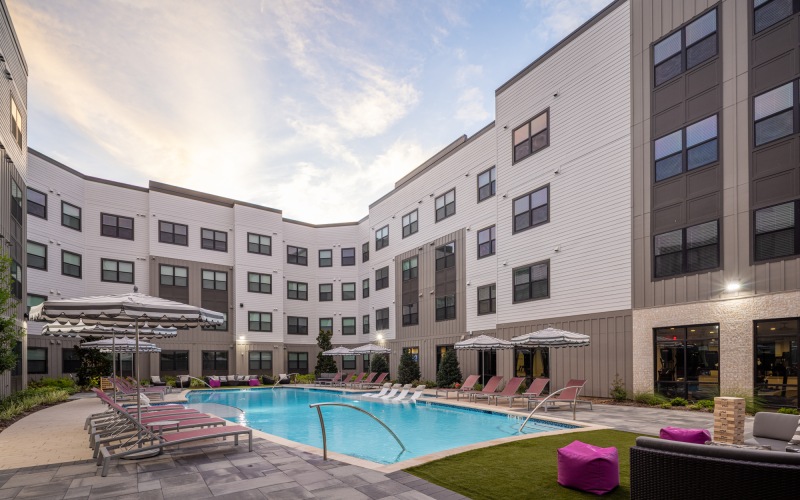 a pool in a courtyard between buildings