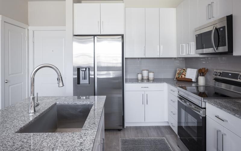 a kitchen with white cabinets