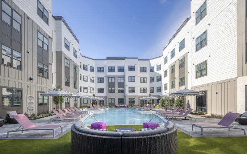 a pool in a courtyard between buildings